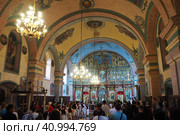 Lacarak, Serbia, 08.05.23 Divine service in the temple dedicated to the worship of God. Christian Orthodox Service. Singing prayers, reading the Holy Scriptures, performing the sacraments and rituals. Редакционное фото, фотограф Юлия Петровская / Фотобанк Лори