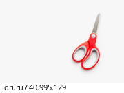 Канцелярские ножницы на белом фоне. Ножницы с красной ручкой. Stationery scissors on a white background. Scissors with a red handle. Стоковое фото, фотограф Ольга Митряева / Фотобанк Лори