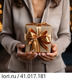A man holding a gift box symbolizing the advent of Christmas and New Year. Created by AI. Стоковое AI-изображение, AI-художник Ярославский Максим / Фотобанк Лори