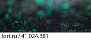 Dark background of abstract glitter. Multicolored sparks on a dark background, defocused, bokeh, banner. Стоковое фото, фотограф Оксана Прахова / Фотобанк Лори