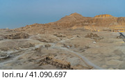 Aerial view of the desert in Luxor. The ongoing archaeological excavations, the ancient temple of Queen Hatshepsut are visible. The mountain is highlighted against the blue sky. Egypt (2021 год). Стоковое фото, фотограф Вера Ивановна Кубарева / Фотобанк Лори