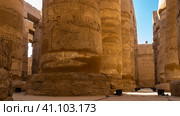 Colonnade in the hypostyle hall of the Karnak Temple. Close-up. Hieroglyphs and carvings are visible on the columns. Blue sky. Egypt. Luxor (2021 год). Стоковое фото, фотограф Вера Ивановна Кубарева / Фотобанк Лори