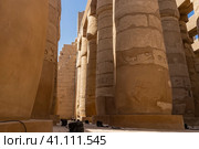 Colonnade in the hypostyle hall of the Karnak Temple. Rows of columns in close-up against the blue sky. Hieroglyphs and carvings are visible. Egypt. Luxor (2021 год). Стоковое фото, фотограф Вера Ивановна Кубарева / Фотобанк Лори