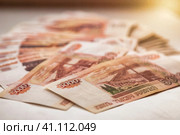 Stack of five thousand russian rubles banknotes one million cash money, selective focus. Close-up of many scattered banknotes 5000 ruble notes on table. Exchange currency concept. Copy ad text space. Стоковое фото, фотограф Aleksandr Golubev / Фотобанк Лори