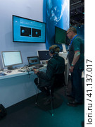 BERLIN, GERMANY - JUNE 01, 2016: The stand of German Aerospace Center (DLR). The simulator remote control technology. Exhibition ILA Berlin Air Show 2016. Редакционное фото, фотограф Sergey Kohl / Фотобанк Лори