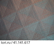 Geometric abstract background from triangles, squares and lines. Three-dimensional bulge. The volume and flex of the diagonally positioned foam material. Green, gray, orange and pink shades. Стоковое фото, фотограф Юлия Петровская / Фотобанк Лори