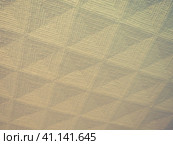 Geometric abstract background from triangles, squares and lines. Three-dimensional bulge. The volume and flex of the diagonally positioned foam material. Yellow and gray retro vintage shades. Стоковое фото, фотограф Юлия Петровская / Фотобанк Лори