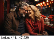 Happy and loving middle aged couple on a romantic date in a cafe in winter. Стоковое AI-изображение, AI-художник Светлана Лажко / Фотобанк Лори