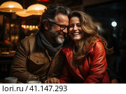 Happy and loving middle aged couple on a romantic date in a cafe in winter. Стоковое AI-изображение, AI-художник Светлана Лажко / Фотобанк Лори