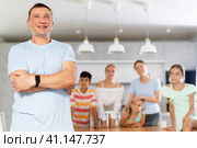 Portrait of happy father of large family against the background of children and his wife in interior of his house. Стоковое фото, фотограф Яков Филимонов / Фотобанк Лори
