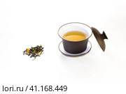 snuff cup with green, flower tea, gaivan and a tea cup on a white background. Стоковое фото, фотограф Татьяна Приймак / Фотобанк Лори