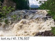 Waterfall during opened locks for idle discharge of water at a small hydroelectric power station. Стоковое фото, фотограф Евгений Харитонов / Фотобанк Лори