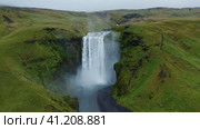 Epic Skogafoss waterfall on Skoga river on South Iceland in summer - aerial drone footage. Popular t. Стоковое видео, видеограф Igor Tichonow / Фотобанк Лори