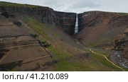 Aerial footage of red stone canyon and beautiful Hengifoss Waterfall in Iceland. Стоковое видео, видеограф Igor Tichonow / Фотобанк Лори