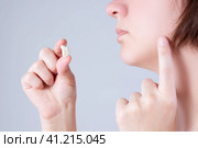 Wisdom tooth extraction, woman suffering from a toothache on gray background. Стоковое фото, фотограф Станислав Тарко / Фотобанк Лори