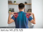 Shoulder-scapular periarthritis, shoulder blades pain, joint inflammation, human skeleton, man with backache at home. Стоковое фото, фотограф Станислав Тарко / Фотобанк Лори