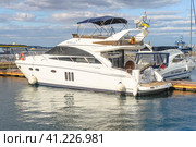The motor yacht Princess 50 is moored in the port. A planing yacht with a flybridge. The sea station of Odessa. The concept of luxury living (2012 год). Редакционное фото, фотограф Воловодов Владимир / Фотобанк Лори