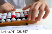 The boy is engaged in abacus, mental arithmetic for children. Стоковое видео, видеограф Igor Skripachev / Фотобанк Лори