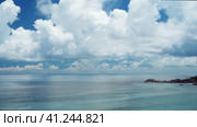 Anse Coco beach on La Digue, Seychelles. Unrecognized tourist swimming in shallow blue ocean lagoon. Стоковое видео, видеограф Igor Tichonow / Фотобанк Лори