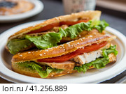 Sandwich of wheat bread with tomatoes, cheese salad, herbs and chicken. Стоковое фото, фотограф Photojuli / Фотобанк Лори