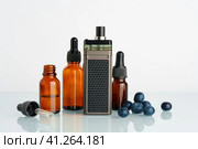 Vape smoking liquid with berry flavor close up. Стоковое фото, фотограф Сергей Толмачёв / Фотобанк Лори