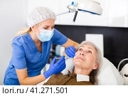 Cosmetologist doing botulotoxin injections for senior woman. Стоковое фото, фотограф Яков Филимонов / Фотобанк Лори