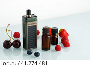 Vape smoking liquid with berry flavor close up. Стоковое фото, фотограф Сергей Толмачёв / Фотобанк Лори