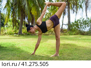 sugarcane pose or ardha chandra chapasana yoga with ukrainian woman making it outdoors. Стоковое фото, фотограф Татьяна Терехина / Фотобанк Лори