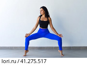 goddess squat or utkata konasana yoga with ukrainian woman making it indoors. Стоковое фото, фотограф Татьяна Терехина / Фотобанк Лори