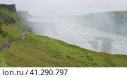 Gullfoss waterfall and silhouette of tourist standing on view platform. Icelandic panoramic landscap. Стоковое фото, фотограф Igor Tichonow / Фотобанк Лори