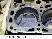 The cylinder block of the four-cylinder engine. Disassembled motor vehicle for repair. Parts in engine oil. Car engine repair in the service. Стоковое фото, фотограф Леонид Еремейчук / Фотобанк Лори