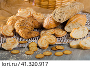 Wheat and grain baguettes, croissants and biscuits on wicker mat. Стоковое фото, фотограф Яков Филимонов / Фотобанк Лори