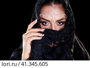 Beautiful Woman in Middle Eastern Niqab veil on isolated black background. Стоковое фото, фотограф Андрей Аркуша / Фотобанк Лори