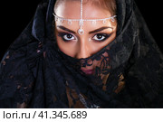 Beautiful Woman in Middle Eastern Niqab veil on isolated black background. Стоковое фото, фотограф Андрей Аркуша / Фотобанк Лори