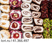 Turkish delight with nuts, pistachios, coconut, chocolate and rose leaves. Rahat lokum, traditional Turkish sweets, Turkey. Стоковое фото, фотограф VittoriaChe / Фотобанк Лори