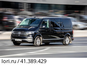 Black Volkswagen Multivan T6.1 riding at the city street. Редакционное фото, фотограф Константин Григорьев / Фотобанк Лори