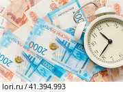 Время-деньги. Время платить налоги. Российские купюры и часы. Time is money. Time to pay taxes. Russian banknotes and watches. Стоковое фото, фотограф Ольга Митряева / Фотобанк Лори