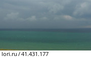 Deep sea. Dramatic thunderclouds over the horizon. Black Sea waves before a hurricane. Storm warning is a forecast of the occurrence of dangerous natural meteorological phenomena. Waves with foam caps. Стоковое видео, видеограф Юлия Петровская / Фотобанк Лори
