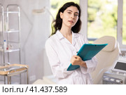doctor meticulously stands in her clinic. Стоковое фото, фотограф Яков Филимонов / Фотобанк Лори