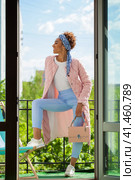African model woman in pink spring jacket and blue pants. Стоковое фото, фотограф Андрей Аркуша / Фотобанк Лори