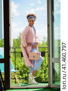 African model woman in pink spring jacket and blue pants. Стоковое фото, фотограф Андрей Аркуша / Фотобанк Лори