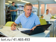 Elder male worker researching with a laptop. Стоковое фото, фотограф Яков Филимонов / Фотобанк Лори