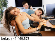 Tired young female employee engaged in programming dozing off at workplace. Стоковое фото, фотограф Яков Филимонов / Фотобанк Лори