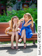 Two young beautiful women secret at summer green park. Стоковое фото, фотограф Андрей Аркуша / Фотобанк Лори