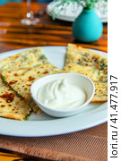 Delicious gourmet flat bread kutabs with herbs and cheese on a plate. Стоковое фото, фотограф Евгений Ткачёв / Фотобанк Лори