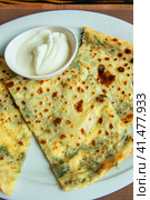 Delicious gourmet flat bread kutabs with herbs and cheese on a plate. Стоковое фото, фотограф Евгений Ткачёв / Фотобанк Лори