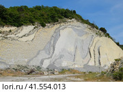 slope of the mountain with layers of sedimentary rocks. Vertically located sedimentary rocks on collapsing hillside. Стоковое фото, фотограф Леонид Еремейчук / Фотобанк Лори