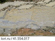 slope of the mountain with layers of sedimentary rocks. Vertically located sedimentary rocks on collapsing hillside. Стоковое фото, фотограф Леонид Еремейчук / Фотобанк Лори