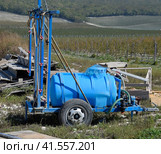 Blue plastic tank for spraying fertilizers and pesticides. Machinery for the care of the vineyard. Стоковое фото, фотограф Леонид Еремейчук / Фотобанк Лори