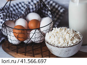 Fresh dairy products, milk, cottage cheese, eggs in stylish ceramic dishes on a gray background. The concept of natural, dietary nutrition. Useful products. Стоковое фото, фотограф Photojuli / Фотобанк Лори